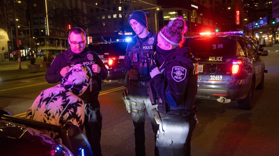 Image: Seattle Police Department officers arrest a woman caught driving a stolen car full of stolen...